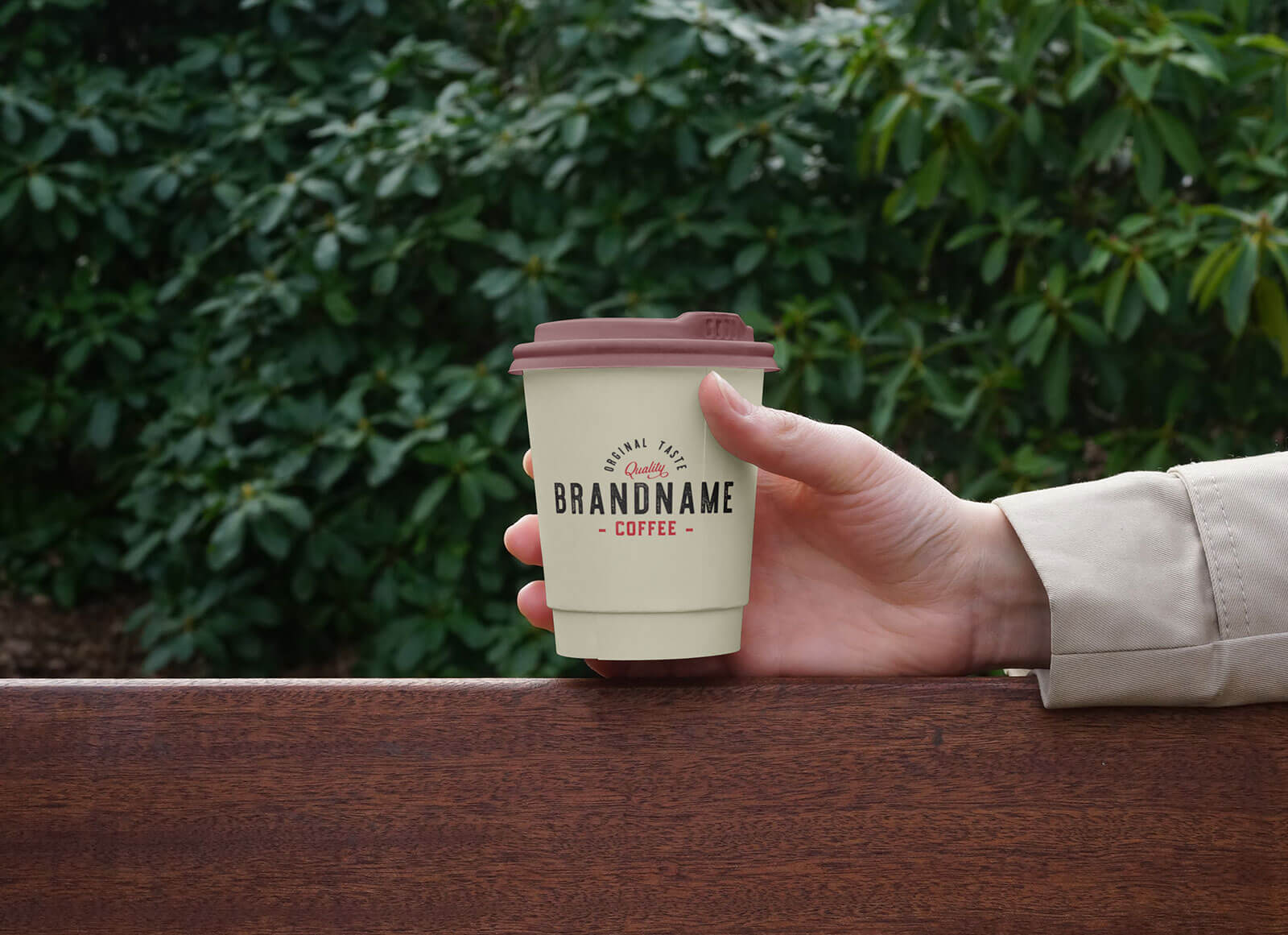 Рука с маленькой бумажной кофейной чашкой макет