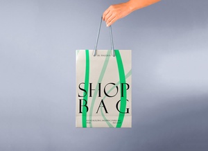 Hand Holding Paper Shopping Bag Mockup