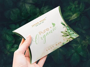 Hand Holding Pillow Box Packaging Mockup